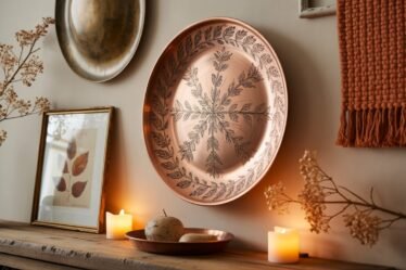 High-end fall living room wall décor with copper wall plates, vintage botanicals, woven textiles, and bronze mirror in warm Pottery Barn–inspired style.