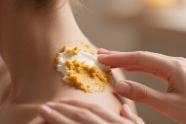 Homemade brightening scrub being applied to neck using natural ingredients like rice flour, yogurt, and turmeric for smooth glowing skin.