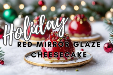 Red mirror glaze cheesecake with biscotti crust topped with pomegranate and pistachio garnish