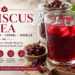Glass of deep red hibiscus tea with dried hibiscus calyces and a hibiscus flower, illustrating the global names, traditions and researched health properties of hibiscus.