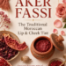 Traditional Moroccan Aker Fassi lip and cheek tint displayed in a decorated terracotta pot with dried petals, pomegranate, red pigment, and elegant gold accents.